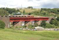 Coal train running onto Jamestown Viaduct on the approach to Inverkeithing in June 2006. In the background is the M90 Motorway and cars parked in the <I>Ferry Toll Park and Ride</I> facility can be seen below the viaduct. On the hill above stands part of the former MoD Pitreavie Maritime HQ (the main underground facility having been closed down and sealed in 1995.)   <br><br>[John Furnevel 20/06/2006]