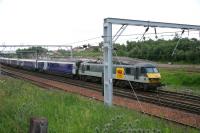 90022 pulls up well north of the platform at Carstairs with the 15 coach Caledonian Sleeper from Euston. The rear 7 coaches will be uncoupled to form the Edinburgh portion following which 90022 will take the remaining 8 on to Glasgow Central. July 2006.   <br><br>[John Furnevel 11/07/2006]